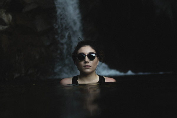 Woman swimming on stream with sunglasses Stock Photo