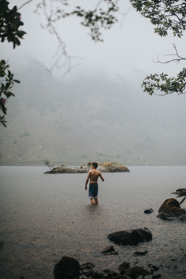 Young man playful on lake in rain Stock Photo