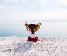 Young woman posing on calm sea scene Stock Photo
