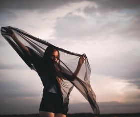 Young woman posing with black cloth Stock Photo
