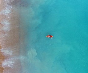 boat on blue empty beach Stock Photo