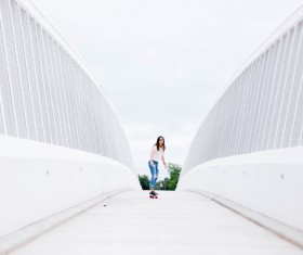 girl play roller skating on white bridge Stock Photo
