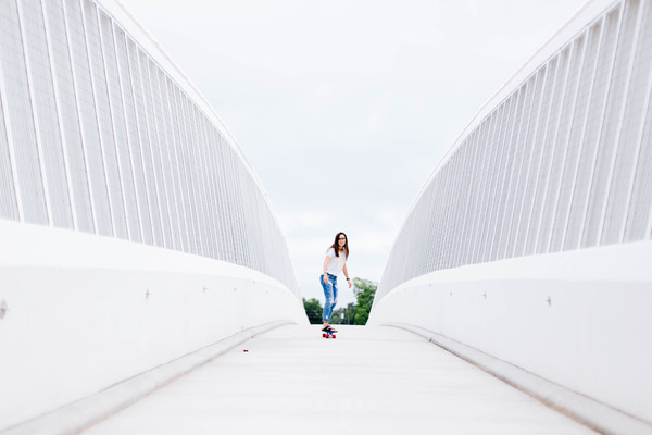 girl play roller skating on white bridge Stock Photo
