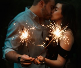 kissing couple and sparkling fireworks candle Stock Photo