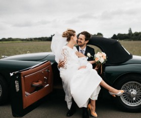 married couple posing on classical car Stock Photo