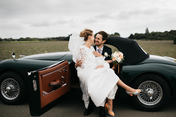 married couple posing on classical car Stock Photo