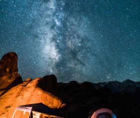 mountain camping under sparkling starry sky Stock Photo