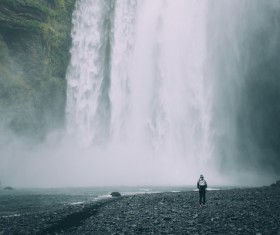 person in front of beautiful waterfall Stock Photo