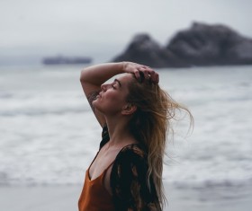 stylish woman posing on beach Stock Photo