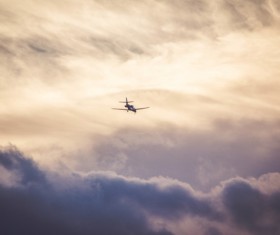 Airplane flying on cloudy sky Stock Photo
