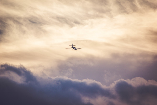 Airplane flying on cloudy sky Stock Photo