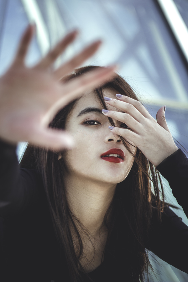 Asian girl hiding from taking pictures Stock Photo