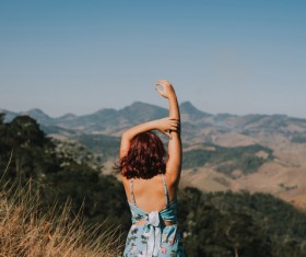Attractive young woman posing on mountain scenery Stock Photo