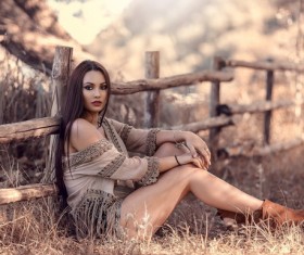 Beautiful hipster girl sitting on the grass Stock Photo