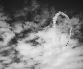 Black white picture of airplane performing on sky Stock Photo