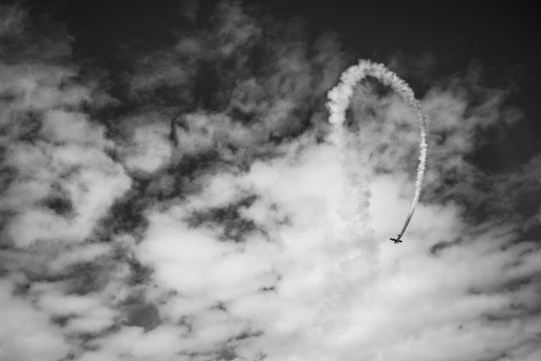 Black white picture of airplane performing on sky Stock Photo
