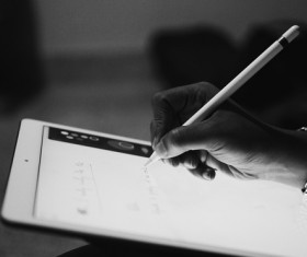 Black white picture of hand writing smart device Stock Photo