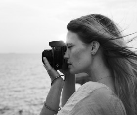 Black white picture of young woman enjoying photographing Stock Photo