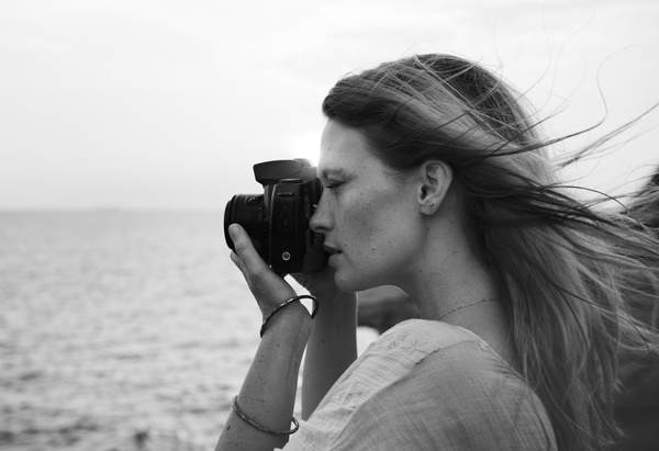 Black white picture of young woman enjoying photographing Stock Photo