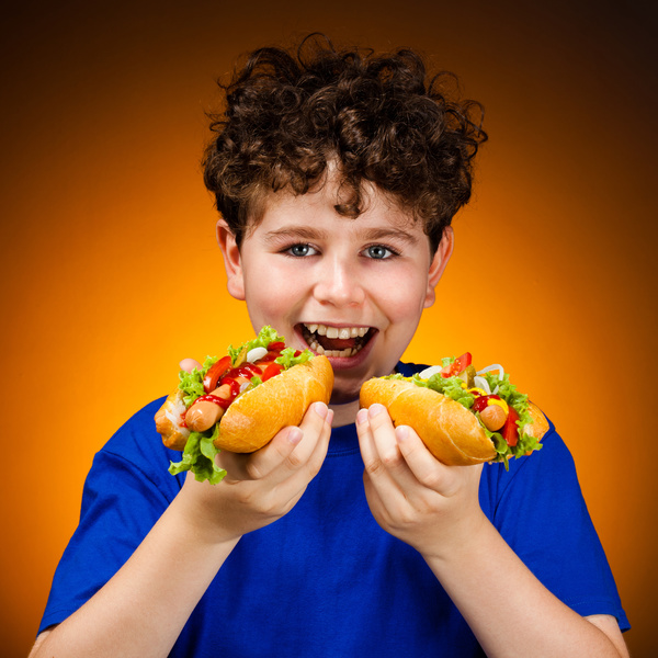 Boy eating hot dog Stock Photo 01