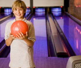 Boy playing bowling Stock Photo