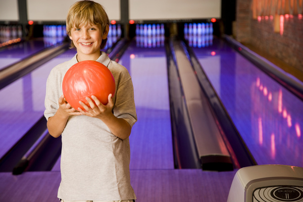 Boy playing bowling Stock Photo