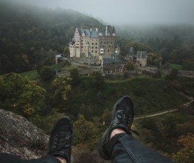 Closeup of man legs and castle landscape Stock Photo