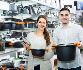 Couple buying cooking utensils Stock Photo