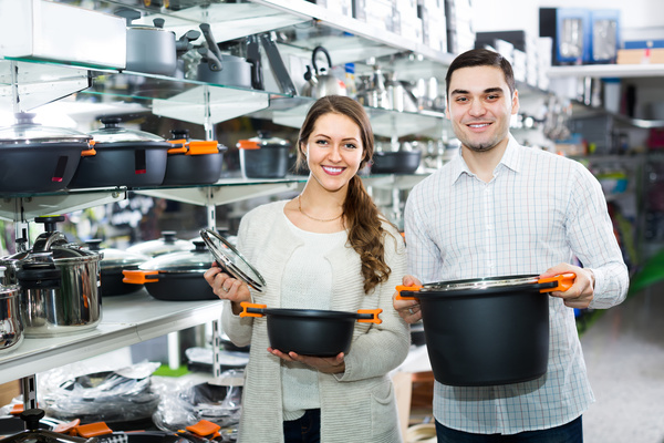 Couple buying cooking utensils Stock Photo