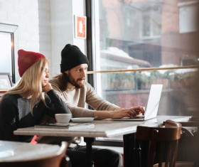 Couple drinking coffee browsing webpage Stock Photo 02