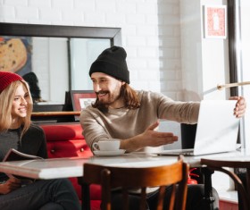Couple drinking coffee browsing webpage Stock Photo 09