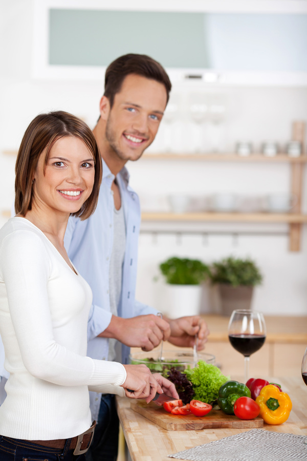 Couple making a salad in the kitchen Stock Photo