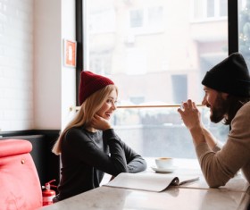 Couple sitting in cafe watching smartphone taking photo Stock Photo 02