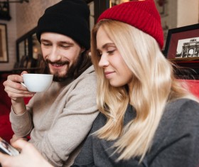 Couple sitting in cafe watching smartphone taking photo Stock Photo 05