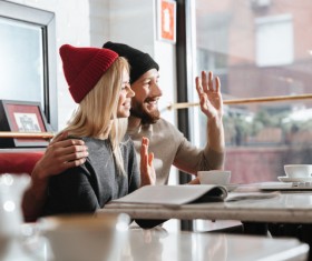 Couple using laptop video chat in cafe Stock Photo 01