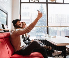 Couple using smartphone selfie in cafe Stock Photo 02