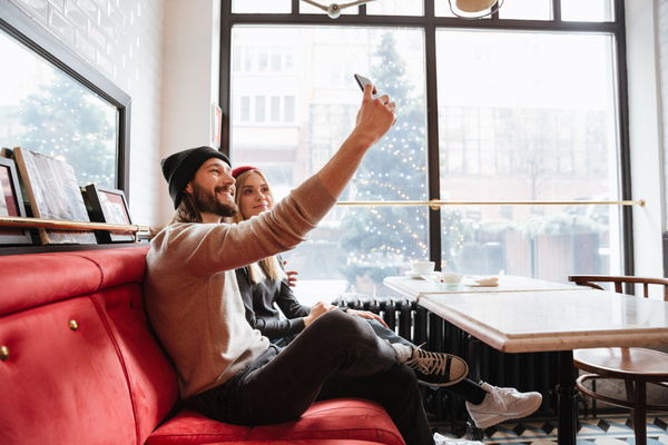 Couple using smartphone selfie in cafe Stock Photo 02