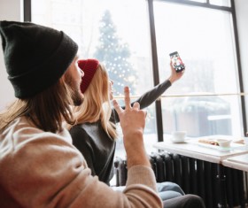 Couple using smartphone selfie in cafe Stock Photo 04