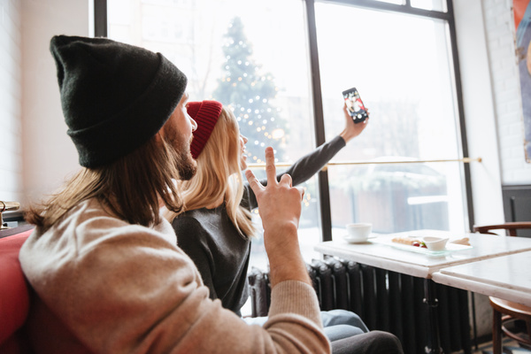 Couple using smartphone selfie in cafe Stock Photo 04