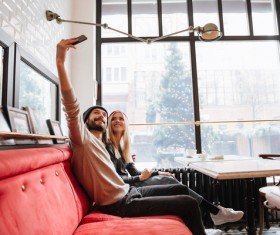 Couple using smartphone selfie in cafe Stock Photo 05
