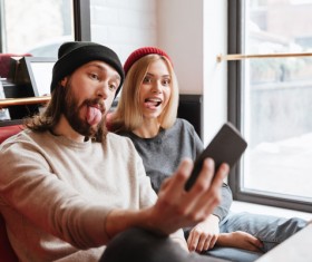 Couple using smartphone selfie in cafe Stock Photo 06