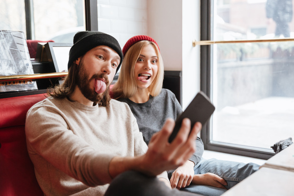 Couple using smartphone selfie in cafe Stock Photo 06