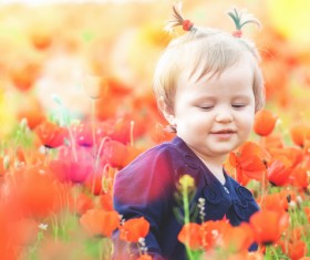 Cute girl among flowers Stock Photo