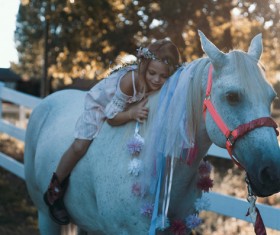 Cute young girl posing on horse back Stock Photo