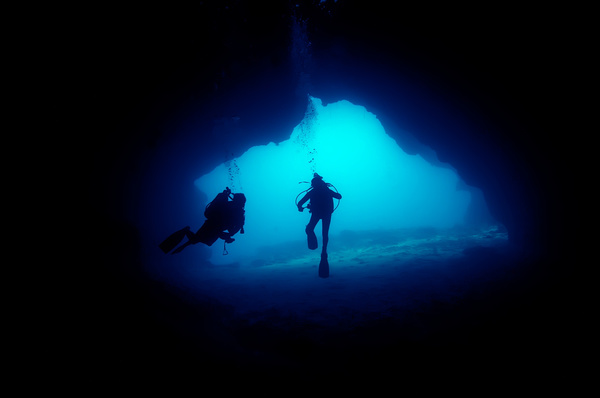 Diver inspect underwater cave Stock Photo 01