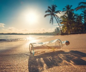 Drifting bottle on the beach Stock Photo