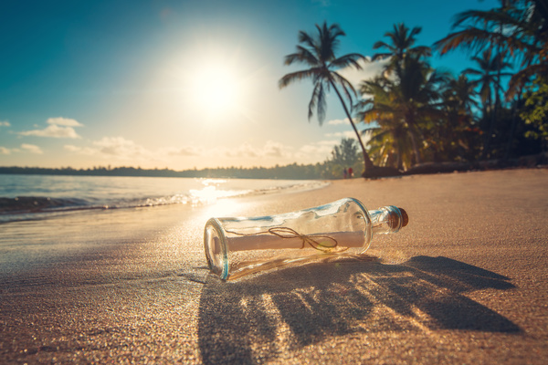 Drifting bottle on the beach Stock Photo