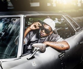 Fashionable black guy sitting in car Stock Photo