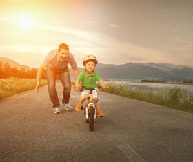 Father watching his son cyclist Stock Photo