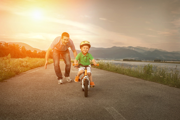 Father watching his son cyclist Stock Photo